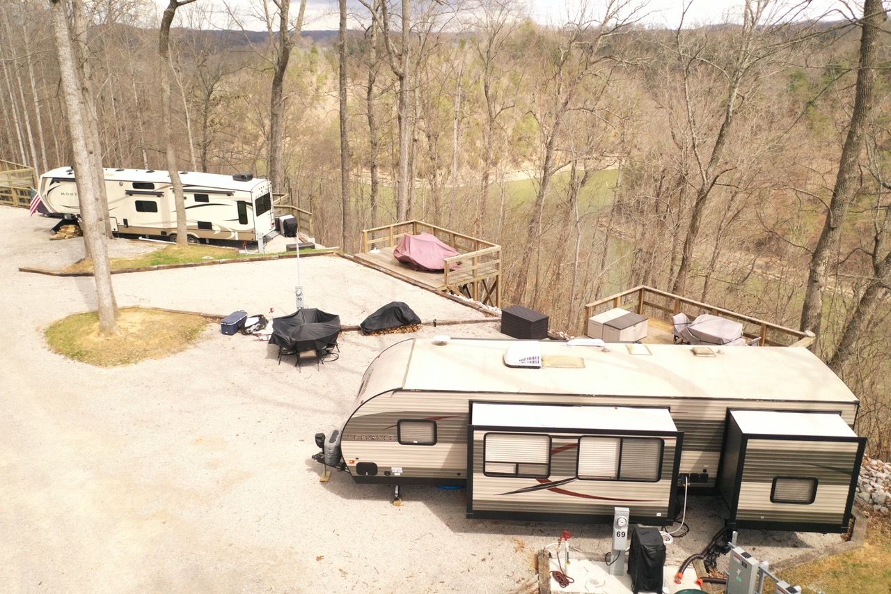 View of RV parking spaces with RVs set up for camp